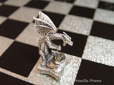 chess board. Silvered-foil and black squares dramatically serve as the 