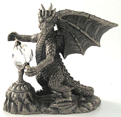 An impressive faceted Swarovski crystal is the focus of this dragon's attention!